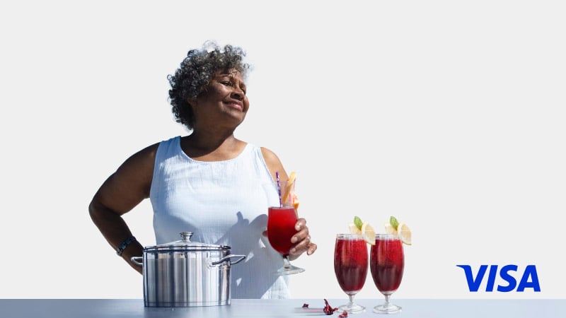 A woman holding a drink in her hand